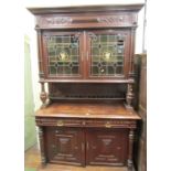A substantial 19th century continental oak buffet on three tiers, the lower section enclosed by