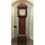 A regency mahogany longcase clock, the hood with reeded columns, enclosing a square painted dial