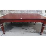 A Victorian mahogany dining table, the rectangular top with moulded outline and rounded corners