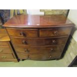 A Victorian mahogany bow fronted bedroom chest of two short over three long drawers raised on turned