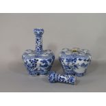 A pair of 19th century oriental flower vases with drawn necks surrounding five apertures, with