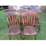 A harlequin set of eight Windsor stained elm and beechwood lathe back kitchen chairs raised on