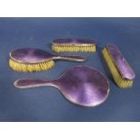1920s silver and purple guilloche enamel four piece dressing set comprising three brushes and