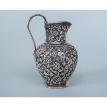 Fine Indian silver baluster cream jug by Oomersi Mawji, cast with various scrolled acanthus and