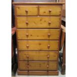 A modern stripped pine bedroom chest of two short over five long drawers with moulded plinth, the