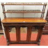 An early Victorian walnut chiffonier of slender proportions, the base enclosed by three mirror