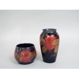 A Moorcroft dark blue ground pomegranate pattern vase 13cm tall approx, with impressed marks and