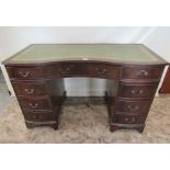 A reproduction Georgian style kneehole twin pedestal writing desk with green leather inset