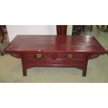 A low Chinese stained soft wood side table of rectangular form, the front elevation fitted with