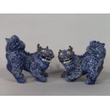 A pair of heavy oriental blue glazed model of open mouthed mythical beasts, 27cm long approx