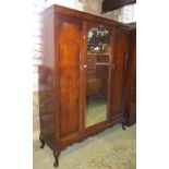 A good quality Edwardian/1920s walnut triple wardrobe with figured veneers and enclosed by three