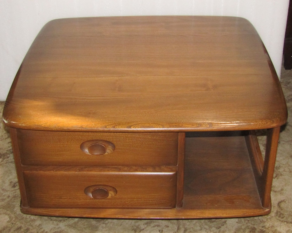 An Ercol Pandora's Box occasional table, with segmented compartments, fitted with two drawers with