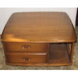 An Ercol Pandora's Box occasional table, with segmented compartments, fitted with two drawers with