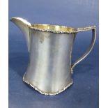 Good quality silver cream jug of waisted cylindrical form, with cast scrolled rim, foot rim and