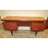 A G-Plan Fresco kneehole dressing table fitted with an arrangement of five drawers, four with