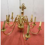 A polished and lacquered brass twelve branch chandelier in the Prussian style 75cm diameter