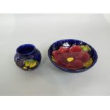A Moorcroft blue ground Clematis pattern footed bowl, 14.5cm diameter, together with a Moorcroft
