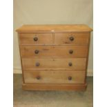 A Victorian stripped pine bedroom chest of two short over three long graduated drawers, flanked by