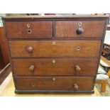 A 19th century oak bedroom chest of two short over three long drawers with kite shaped