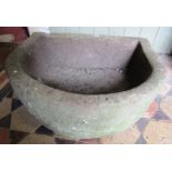 A natural stone D shaped trough 56 cm wide x 47 cm deep x 20 cm in height approx