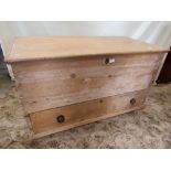 A Victorian stripped pine blanket box with hinged lid enclosing a candle box and two small drawers