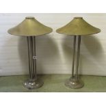 A pair of vintage chrome table lamps, with coolie hat style shades, raised on four vertical rod