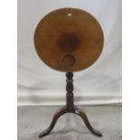 A small 19th century snap top occasional table of circular form, raised on a turned pillar and
