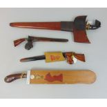 Four Malaysian Kris daggers, one with interesting carved hardwood handle, all within wooden sheaths