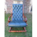 A good quality reproduction Regency style rocking chair with green leather button upholstered