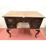 A Georgian walnut lowboy, fitted with five drawers raised on pronounced shaped forelegs with cast
