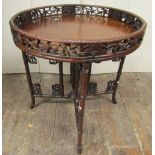 A good quality Chinese hardwood occasional table, the circular top with carved and pierced