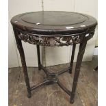 A Chinese hardwood occasional table, the circular top with carved and pierced frieze, raised on four