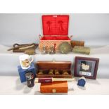 A mixed collection of miscellaneous items to include a basket of coins, a collection fo ethnic