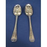 Pair of early Georgian silver berry serving spoons with typical embossed bowls and engraved handles,