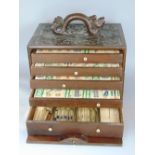 Mahjong Interest - A complete Mahjong set within a carved Chinese hardwood case, the top with coiled