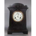 Arts & Crafts stained oak mantle clock, the convex enamel dial with Arabic and Roman numerals,