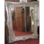 A large contemporary reproduction wall mirror of rectangular form with bevelled edge plate within