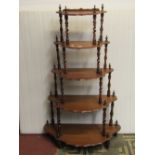 A Victorian mahogany floorstanding whatnot on five graduated tiers with pie crust moulded outline