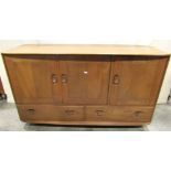 An Ercol medium to light elm sideboard enclosed by three doors over two drawers with oval dished