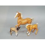 A Beswick Palomino prancing pony, together with a Beswick Palomino foal and Beswick Jersey calf