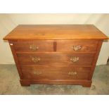 An Edwardian walnut dressing chest of two short over two long graduated drawers with later brass