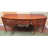 An early 19th century mahogany bow front kneehole sideboard, with one shallow drawer and two deep