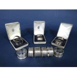 Three cased pairs of silver napkin rings, together with six further napkin rings, 3.5oz approx