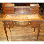 An inlaid Edwardian mahogany ladies writing desk fitted with an arrangement of five drawers on