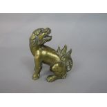 Chinese polished cast bronze figure of a seated dog of fo, 10cm high