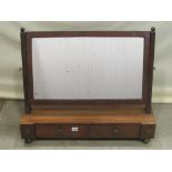 A Regency mahogany toilet mirror of rectangular form with reeded supports raised on a box base