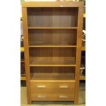 A contemporary oak veneered bookcase or shelving unit, freestanding and partially fitted with two