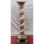 An antique torchere with spiral twist column supports, set on a square cut plinth, with a gesso
