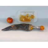 An eastern dagger with overlaid handle, a small collection of amber type resin, etc