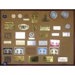 A cork board displaying a number of vintage transport rally plaques, circa 1980/2000